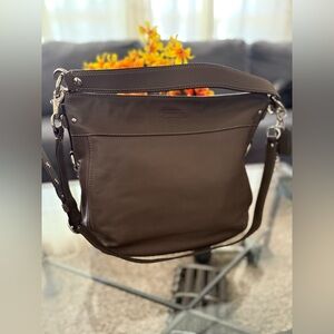 The Coach F14706 is a vintage-style large "Zoe" hobo shoulder bag